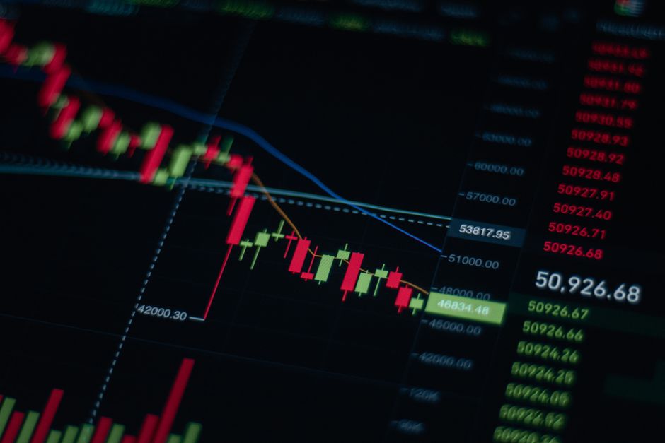 Stock market data and trend chart displayed on a digital monitor, showing upward market momentum.