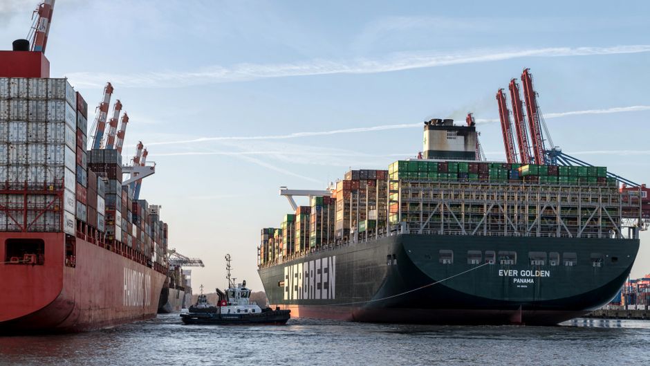 Cargo ships moving through a major port as energy-supply risks intensify.