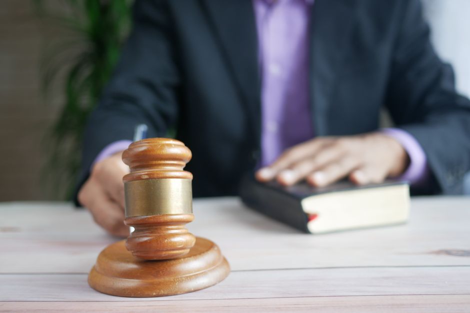 A wooden gavel resting on a legal book, symbolizing legislative authority and the rule of law