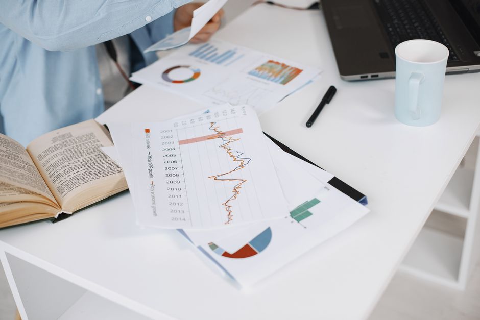 Office workspace with data charts and laptop on a desk